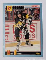 Front of 1991 Score hockey card featuring Mario Lemieux in Pittsburgh Penguins uniform with '92 Season Leader Points title.