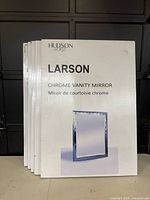 Photo of the product manuals for Larson Chrome Vanity Mirrors indicating product name and brand.