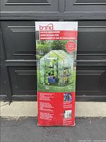 Front view of the boxed walk-in greenhouse showing brand and product name with image of assembled greenhouse.