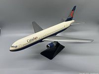 Front-side view of the Canadian Airlines model airplane showing fuselage details and stand.