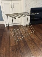 Front angle view of the vintage brass LP holder showing structure and design.