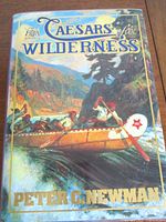 Front cover of the book 'Caesars of the Wilderness' by Peter C. Newman showing detailed wilderness canoe scene artwork on dust jacket.