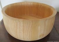 Top angled view of the large vintage teak salad bowl showing the smooth, staved wood construction and rounded edges.