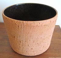 Side view showing textured terracotta exterior with faux cork look.