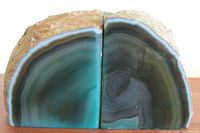 Front view of the pair of agate quartz geode bookends showing polished interiors with turquoise, blue, teal, grey, and black bands.