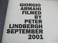 Front page of the look book showing bold black text stating "GIORGIO ARMANI FILMED BY PETER LINDBERGH SEPTEMBER 2001" on white background.