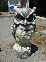Front view of the resin owl decoy showing detailed facial features and body texture with natural coloring.