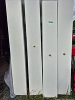 Front view of four white bi-fold doors standing upright