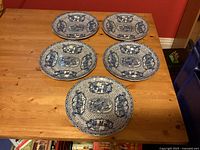 Five blue and white Adams Chinese Rose dinner plates on wooden surface