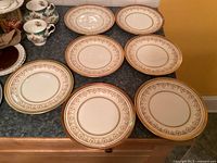 Seven Aynsley Gold Dowry lunch plates displayed front view
