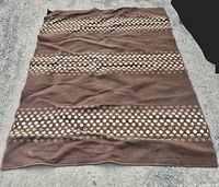 Full view of brown rug laid flat showing overall pattern and size