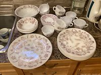 Overview of 27-piece Federal Glass dinnerware set on countertop