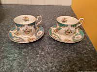 Two Rosina Centenary Year teacups with saucers showing pattern and condition