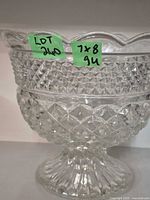 Side view of pressed glass pedestal bowl showing diamond pattern and scalloped rim with size notes