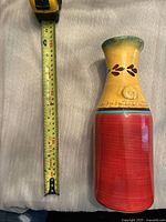 Casa Domani ceramic pitcher placed next to a tape measure showing a height of approximately 11 inches.