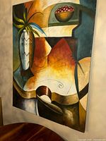 Frontal view of the oil painting showing the full canvas with abstract shapes including a vase, bowl of fruit, and geometric elements.