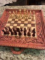 Front view of chess board with full set of pieces arranged for play
