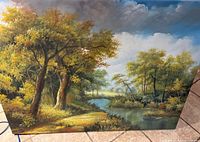 Photo showing the full landscape oil painting with trees, river, clouds, and artist's signature