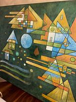 Front view of the painting showing the full geometric abstract design with blue circle near center and several yellow triangular shapes.
