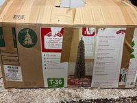 Box showing front labeling, 7-foot pre-lit slim Christmas tree with model T-36 Clear and product features