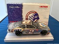 Front and side view of 1:24 scale Rusty Wallace Miller Lite die-cast model car with original box in background