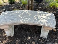 Front side view showing curved top with decorative edging and ornamental concrete legs.