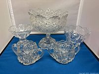Front view of entire set with large pedestal fruit bowl, two sugar bowls with handles, and two smaller candy bowls on sides.