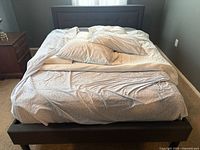 Full bed frame with mattress and bedding visible to show overall appearance and upholstery.