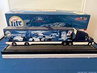 Side view of the die-cast truck and trailer displayed on a base with detailed Miller Lite Racing and Rusty Wallace themed graphics.