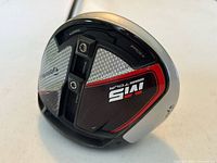 Close-up of the sole of the TaylorMade M5 golf driver showing adjustable weight track and brand markings.