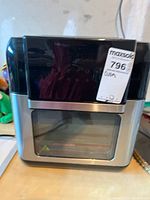 SYXY air fryer oven closed showing black and silver exterior with label on front.