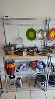 Full view of the assembled metal baker's rack holding various cookware items.