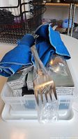 Several forks wrapped in plastic with decorative handles identifiable as Arthur Price flatware