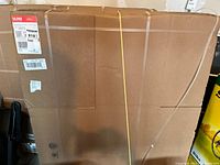 Large flat sealed cardboard boxes labeled Uline with shipping labels and straps visible.