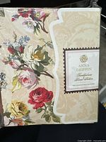 Front view of the closed pack showing floral designs and product label with brand and product name.