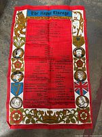 Full view of the textile showing its rectangular shape, the red genealogical chart center, and the decorated borders with royal symbols and portraits.
