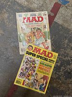 Two MAD magazines placed on a floor: Mad Super Special No. 25 and Mad Animal House June 1979 issue