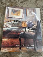 Front cover of the book showing an artwork of a sitting area with furniture and cushions, 'Timothy J. Clark' text visible.