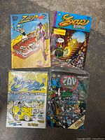 Top view of four Zap Comix issues No. 1, 3 (Special 69), 5, 10 showing covers with colorful and detailed illustrated adult content.