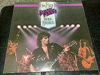 Front cover of April Wine LP The Best of Rock Ballads with band performing under stage lights