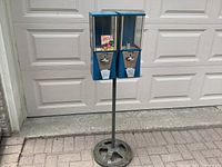 Full view front of the double head gumball vending machine on stand showing coin mechanisms and 'Chicle Tabs' sticker.