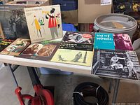 Vinyl records on table showing a mix of jazz albums with worn covers