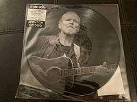Front side of the picture disc showing Gregg Allman playing acoustic guitar.