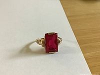 Front view of ring showing rectangular red stone set in gold