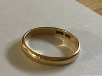 Side profile of ring showing band shape and interior hallmarks