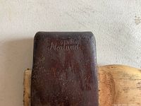 Close-up of the axe head showing the engraved 'GENUINE Norland' marking on metal surface.