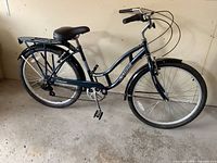 Side view of complete bike showing step-through frame, saddle, rear rack and fenders