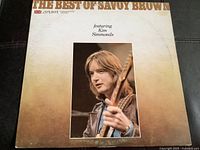 Front cover of 'The Best of Savoy Brown' LP showing Kim Simmonds playing guitar, with visible wear but overall near mint condition.