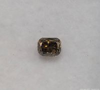Close-up front view of the diamond showing cushion cut with dark facets.