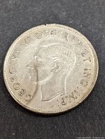 Obverse side showing profile portrait of King George VI and inscription